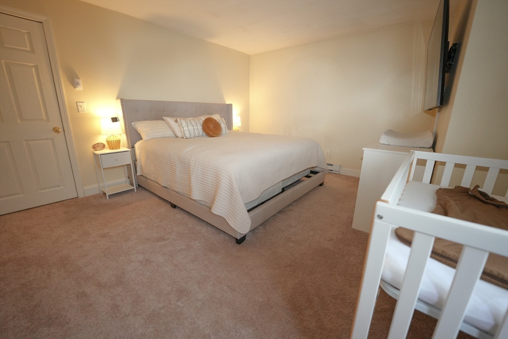 90-92 Sandwich Road, Unit 9C Bourne, MA 02532 - Photo 8 of 10 a bedroom with a bed and a window