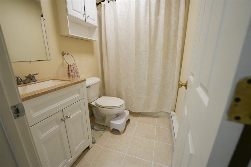 90-92 Sandwich Road, Unit 9C Bourne, MA 02532 - Photo 10 of 10 a bathroom with a sink toilet and shower