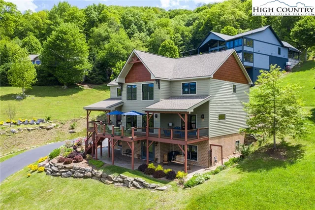an aerial view of a house with swimming pool garden and patio