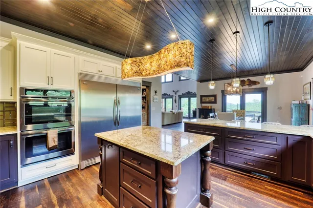 a kitchen with granite countertop stainless steel appliances and wooden cabinets