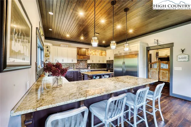 a kitchen with granite countertop lots of counter top space and stainless steel appliances