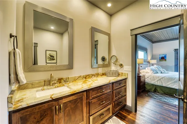 a en suite bathroom with double sink and a mirror