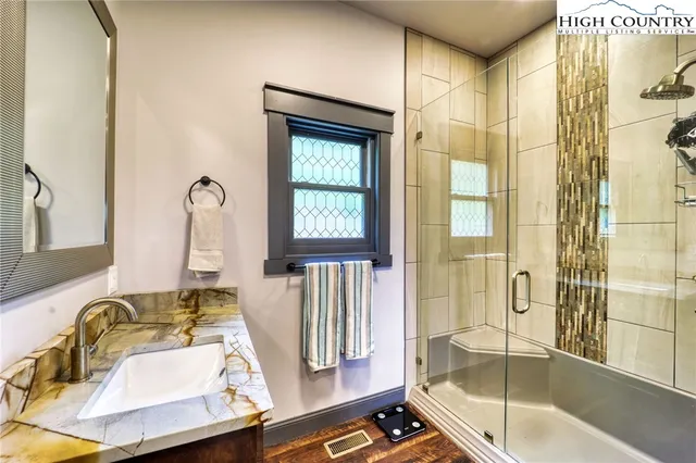 a view of a bathroom with mirror on the wall