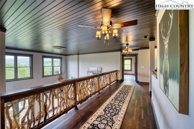 a bedroom with a large bed and windows