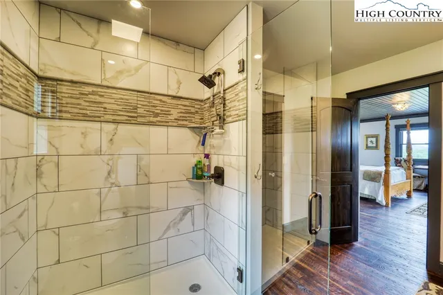 a bedroom with a bed and a large window