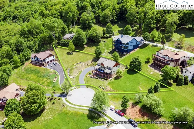 an aerial view of a house with a garden and swimming pool