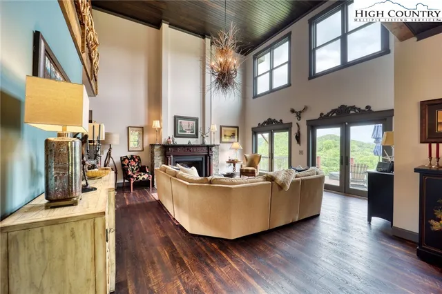 a living room with furniture and large windows