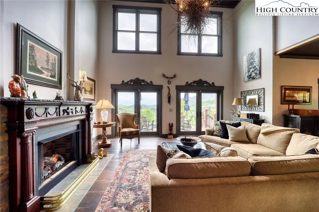 a living room with furniture a large window and a fireplace
