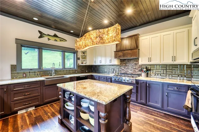 a kitchen with a stove a sink and cabinets