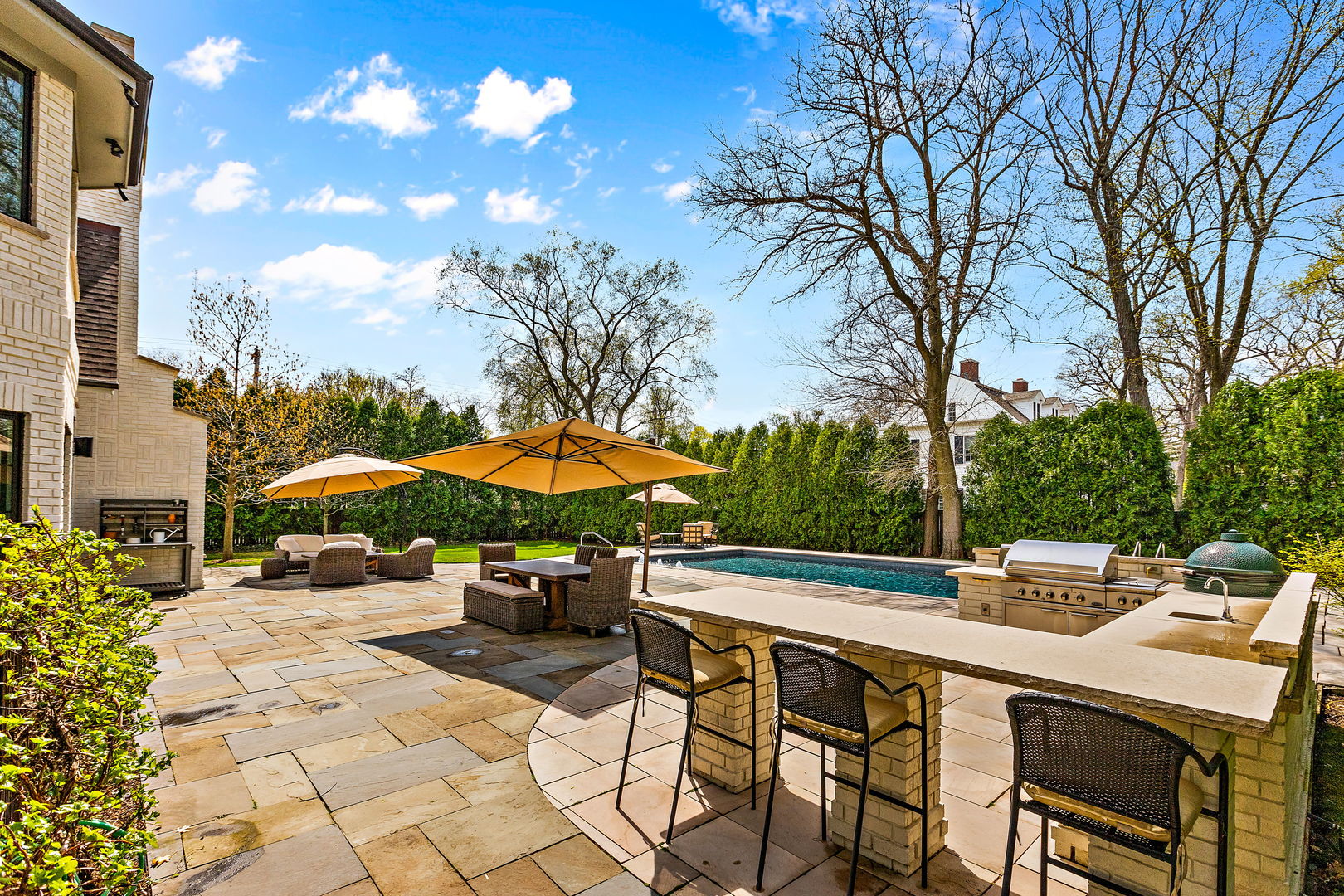 368 Ridge Avenue Winnetka, IL 60093 - Photo 43 of 55 a view of patio with chairs and table under an umbrella with a barbeque