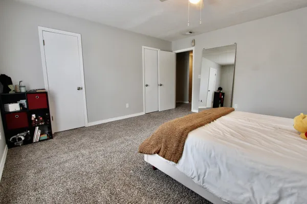 a bedroom with a bed and a chandelier