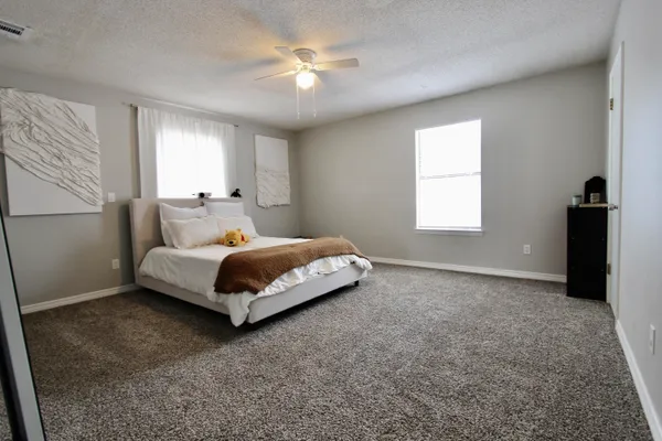 a bedroom with a bed and a window