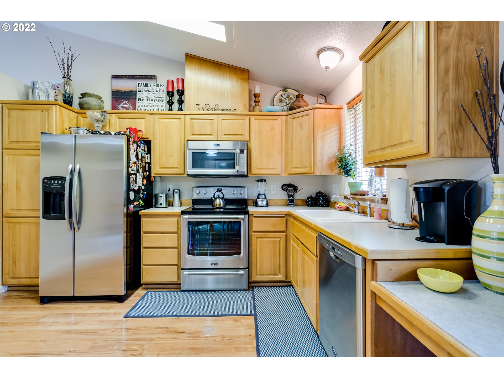 5502 E Street Springfield, OR 97478 - Photo 7 of 17 a kitchen with stainless steel appliances a stove a sink and a refrigerator