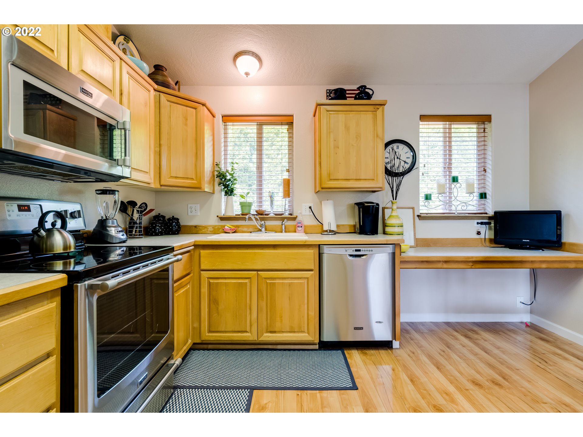 5502 E Street Springfield, OR 97478 - Photo 8 of 17 a kitchen with stainless steel appliances a stove a sink and a microwave