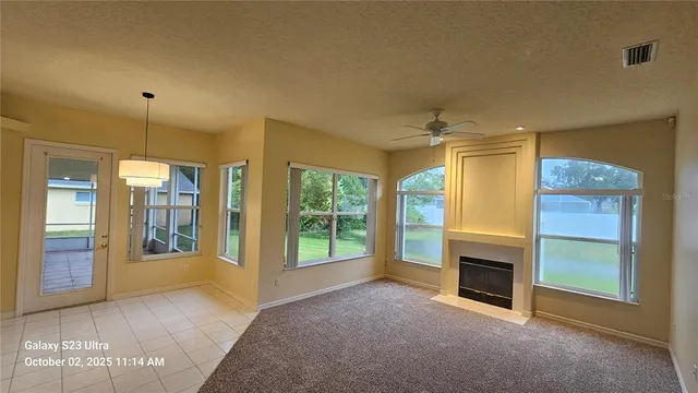 a view of a livingroom with a fireplace and window