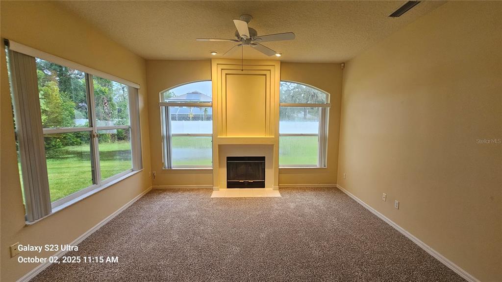 41 Creek Bluff Way Ormond Beach, FL 32174 - Photo 17 of 33 a view of a livingroom with a fireplace and large windows