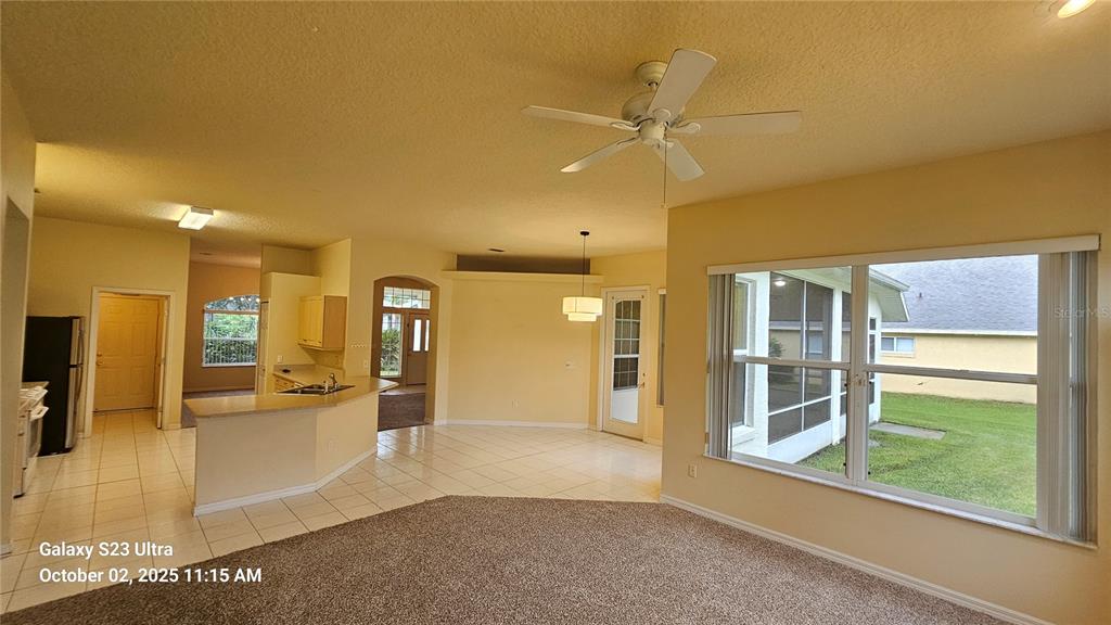 41 Creek Bluff Way Ormond Beach, FL 32174 - Photo 19 of 33 a view of a big room with wooden floor kitchen view and windows