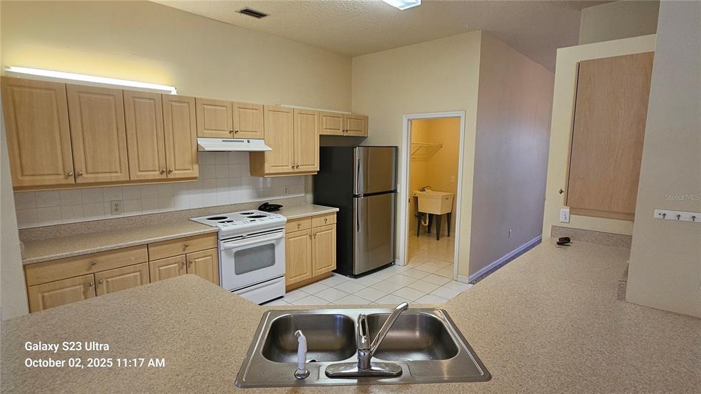 41 Creek Bluff Way Ormond Beach, FL 32174 - Photo 23 of 33 a kitchen with a sink cabinets and refrigerator