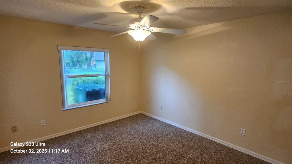 41 Creek Bluff Way Ormond Beach, FL 32174 - Photo 24 of 33 an empty room with a chandelier fan and windows