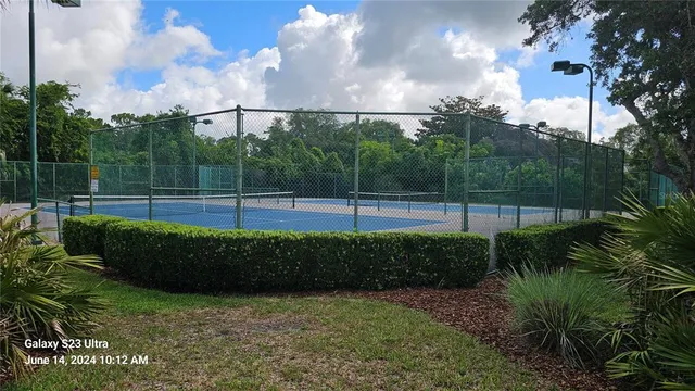 a aerial view of a golf course with a tree