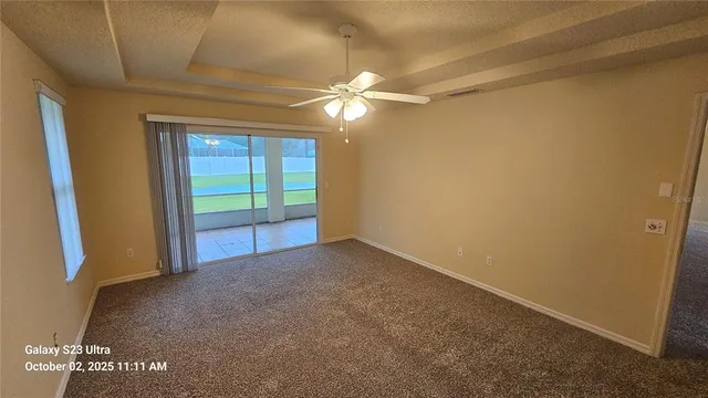 a view of empty room with ceiling fan