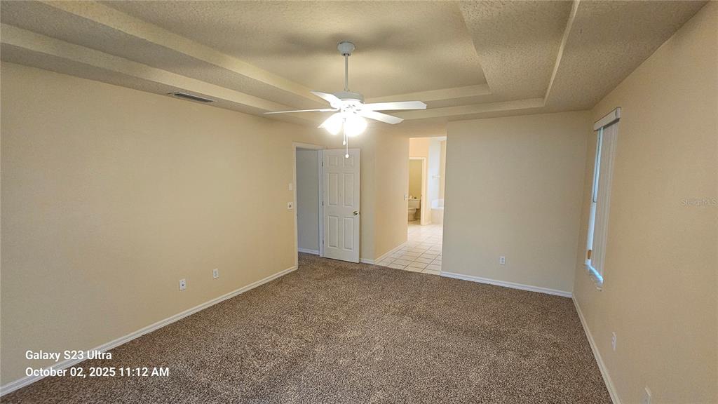 41 Creek Bluff Way Ormond Beach, FL 32174 - Photo 9 of 33 an empty room with a ceiling fan and a window