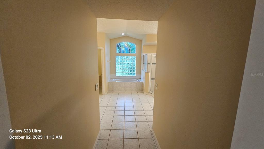 41 Creek Bluff Way Ormond Beach, FL 32174 - Photo 10 of 33 a view of a hallway with wooden floor and a bathroom