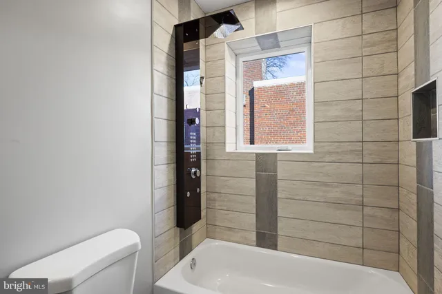 a bathroom with a toilet and shower