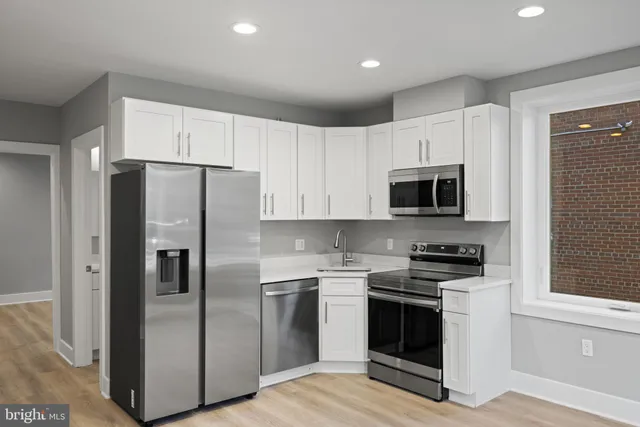 a kitchen with stainless steel appliances a refrigerator stove and microwave