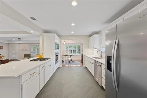 a large white kitchen with a lot of counter space