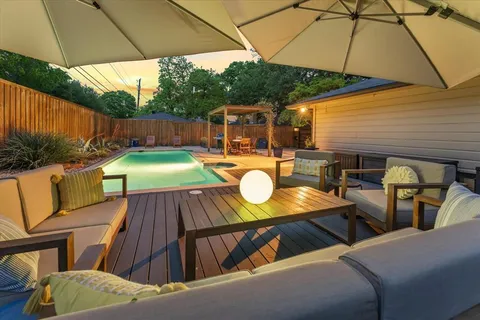 a view of a patio with table and chairs under an umbrella