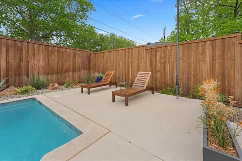 a view of outdoor space with seating area and wooden fence