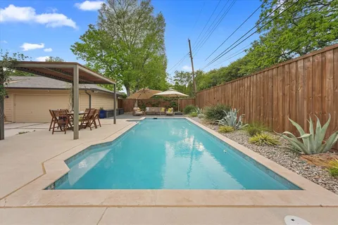 a swimming pool view with a outdoor seating