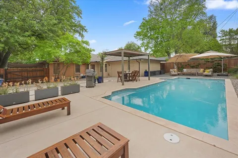 a view of a swimming pool with chairs