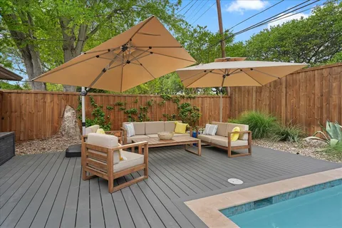 a view of patio with a table and chairs under an umbrella