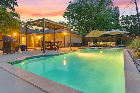a view of a swimming pool with a patio