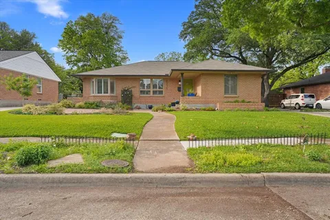 a front view of a house with a garden and a garden