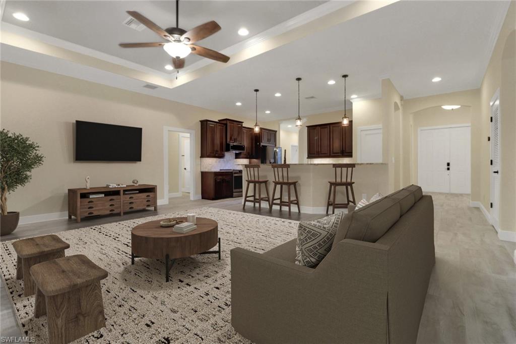 17094 Wrigley Circle Fort Myers, FL 33908 - Photo 11 of 33 a living room with furniture a flat screen tv and kitchen view