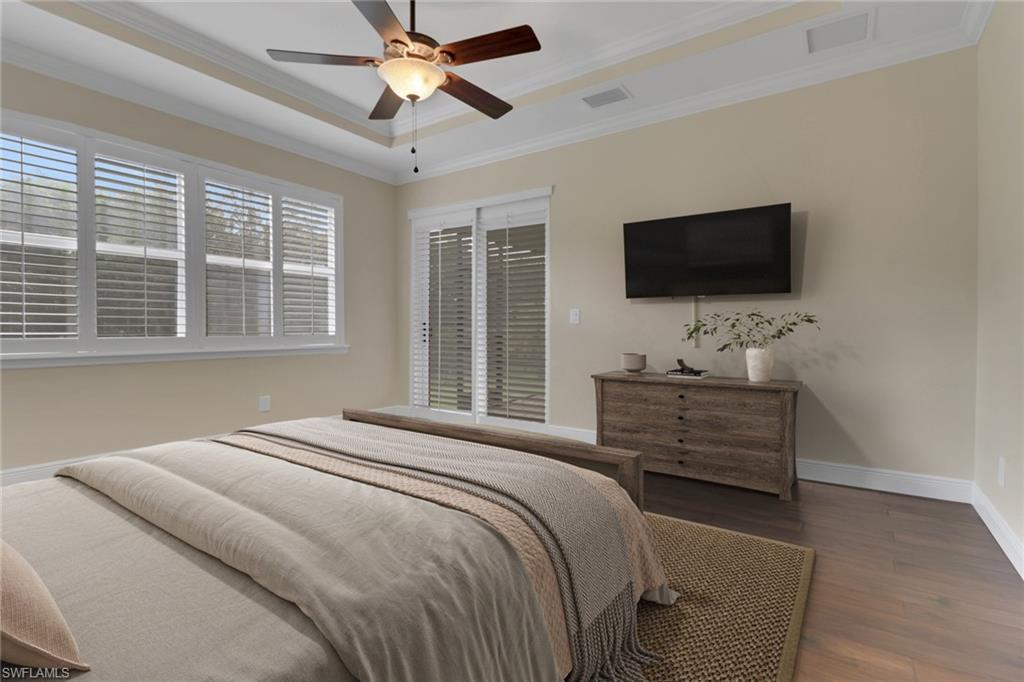 17094 Wrigley Circle Fort Myers, FL 33908 - Photo 16 of 33 a bedroom with a bed and a flat screen tv