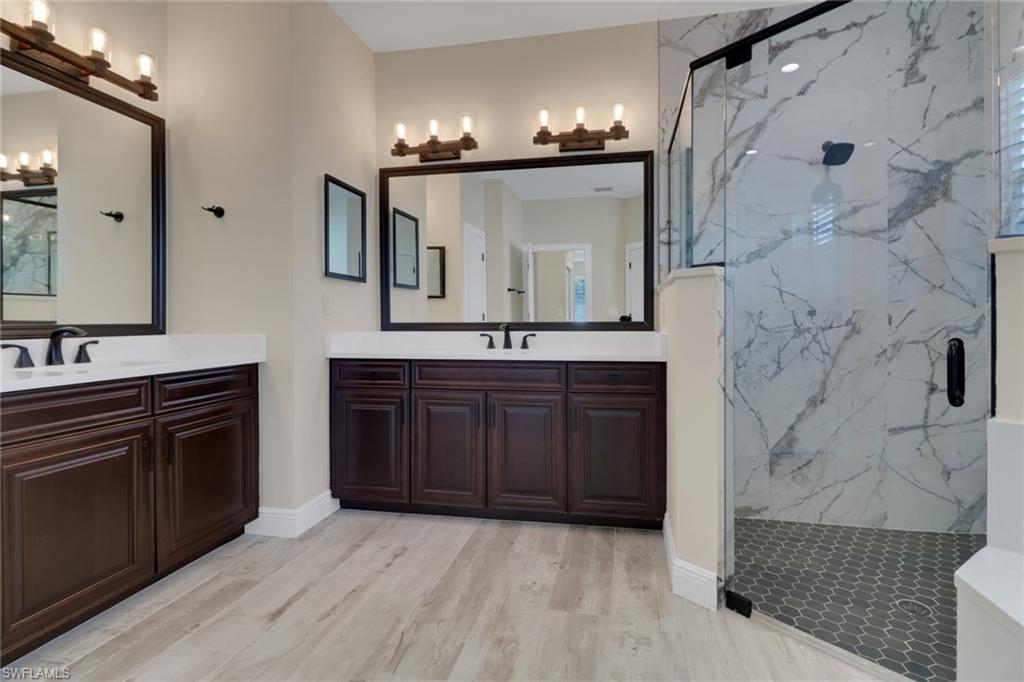 17094 Wrigley Circle Fort Myers, FL 33908 - Photo 17 of 33 a spacious bathroom with a granite countertop double vanity sink and a mirror