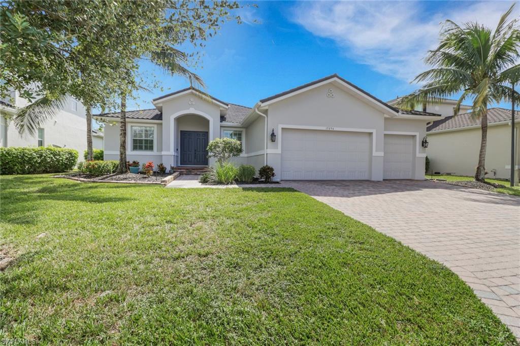 17094 Wrigley Circle Fort Myers, FL 33908 - Photo 2 of 33 a front view of a house with a yard and garage