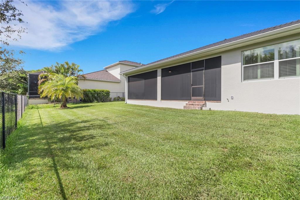 17094 Wrigley Circle Fort Myers, FL 33908 - Photo 26 of 33 a front view of house with yard and green space