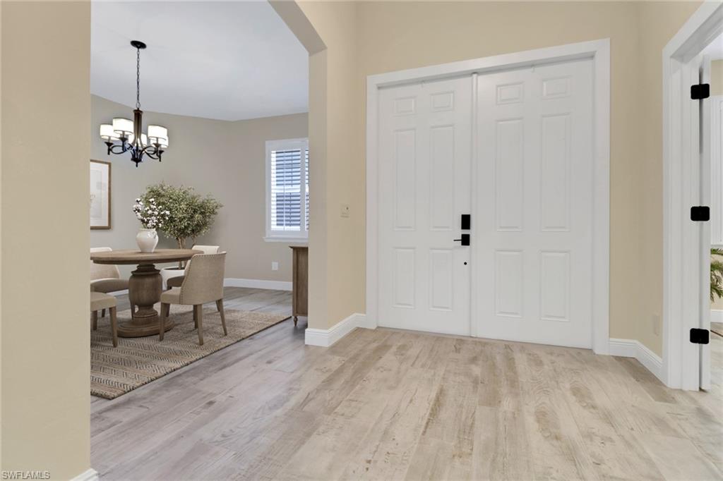 17094 Wrigley Circle Fort Myers, FL 33908 - Photo 3 of 33 a view of a room with wooden floor table and chairs