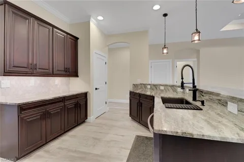 a kitchen with a sink appliances and cabinets