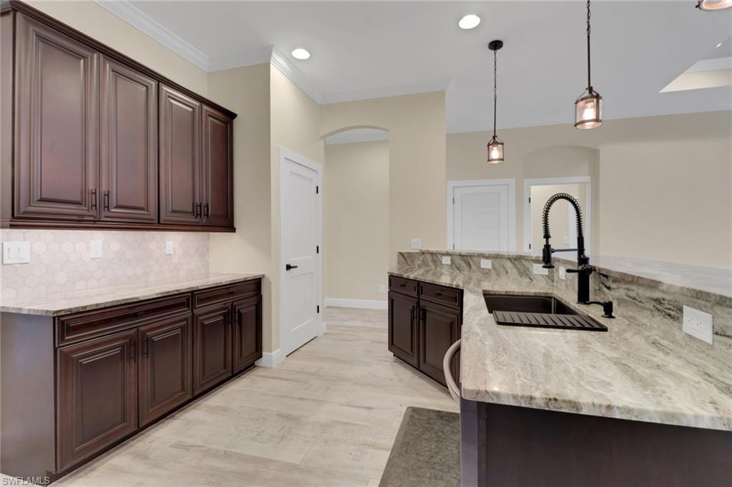 17094 Wrigley Circle Fort Myers, FL 33908 - Photo 8 of 33 a kitchen with a sink appliances and cabinets