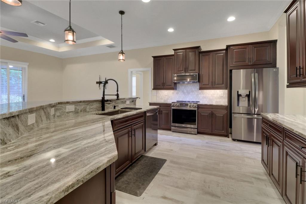 17094 Wrigley Circle Fort Myers, FL 33908 - Photo 10 of 33 a kitchen with granite countertop a sink stainless steel appliances and cabinets