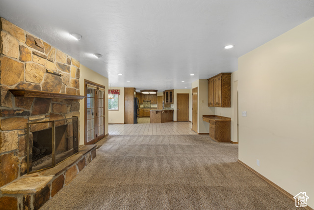 1373 Pheasant Ridge Circle Bountiful, UT 84010 - Photo 6 of 50 Stone-clad fireplace with a wood mantel, glass double doors, recessed lighting, built-in desk, and wood cabinetry