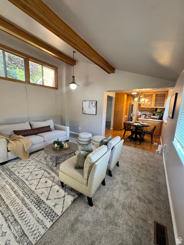 4245 3320 East Holladay, UT 84124 - Photo 16 of 51 Vaulted ceiling with exposed wood beams, bright recessed windows, and a central pendant light fixture