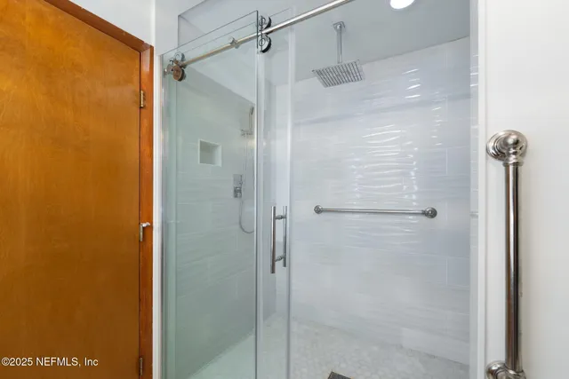 a bathroom with a glass door shower