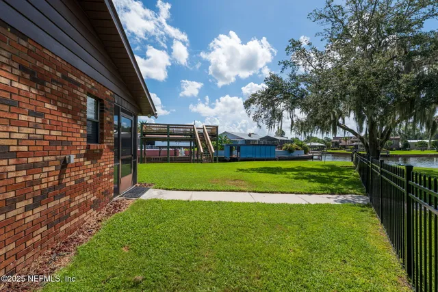 a view of a house with a backyard